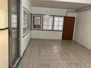 Spacious empty living room with patterned tiled flooring and multiple windows