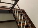 Wooden staircase with metal railings in a residential property