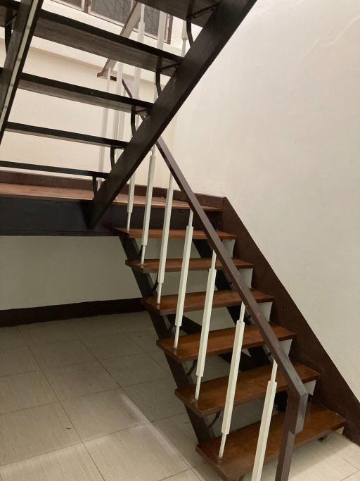 Wooden staircase with metal railings in a residential property