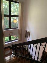 Staircase area with a view of the greenery through the window