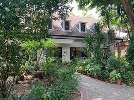 Cozy house surrounded by greenery with a welcoming pathway