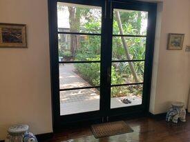 Spacious living room with large garden view windows and natural lighting