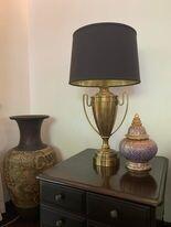 Elegant bedroom decor with a stylish lamp and ornamental vases on a dresser