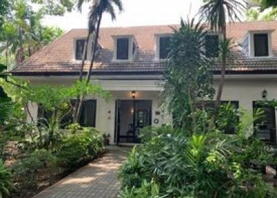 Front view of a well-landscaped house with lush garden