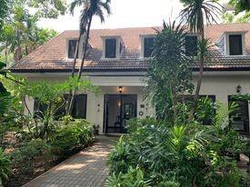 Front view of a well-landscaped house with lush garden