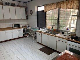 Spacious kitchen with white cabinetry and natural light