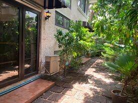 Cozy patio area with lush greenery outside a home