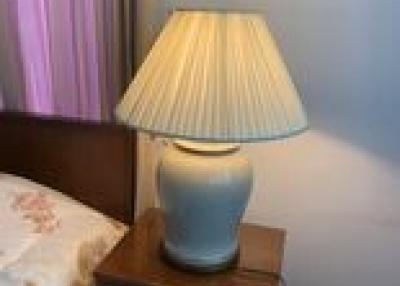 Bedside table with lamp in a bedroom setting