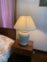 Bedside table with lamp in a bedroom setting