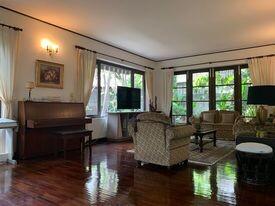 Spacious living room with natural lighting and hardwood floors