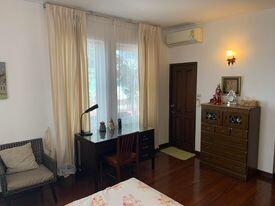 Cozy bedroom with natural lighting and wooden flooring