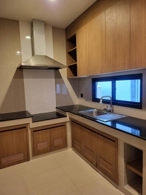 Modern kitchen with wooden cabinets and stainless steel appliances