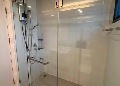 Modern glass-enclosed shower in a clean and well-lit bathroom