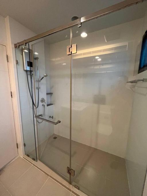 Modern glass-enclosed shower in a clean and well-lit bathroom