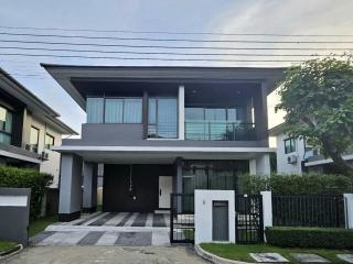 Modern two-story house with large windows and a garage