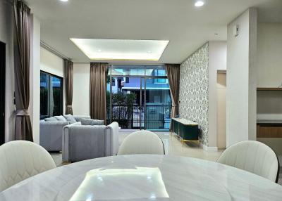 Spacious modern living room with dining area and balcony access