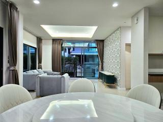 Spacious modern living room with dining area and balcony access