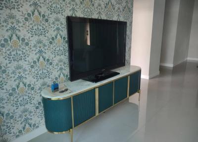 Modern living room with stylish wallpaper and entertainment unit