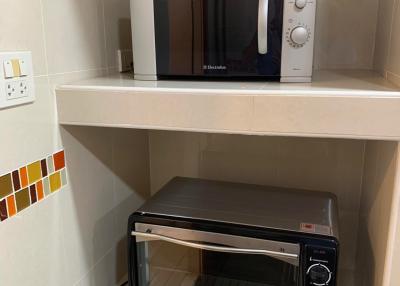 Compact kitchen area with microwave and toaster oven
