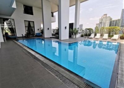 Modern pool area with cityscape view in a luxury apartment complex