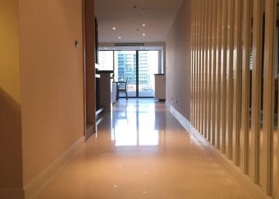 Spacious and well-lit hallway leading to a living area with balcony access