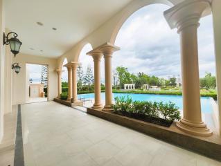 Luxurious home exterior with archways and a swimming pool
