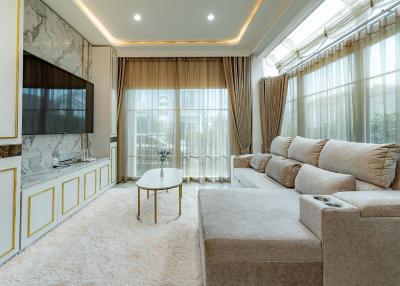 Elegant living room with modern furnishings and abundant natural light