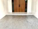 Elegant wooden front door with terrazzo flooring at the entrance