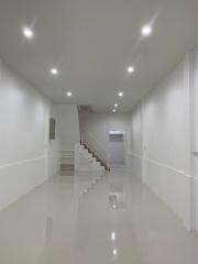 Modern home interior of a bright and spacious hallway with staircase