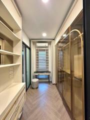 Modern hallway interior with built-in wardrobes and a seating area by the window