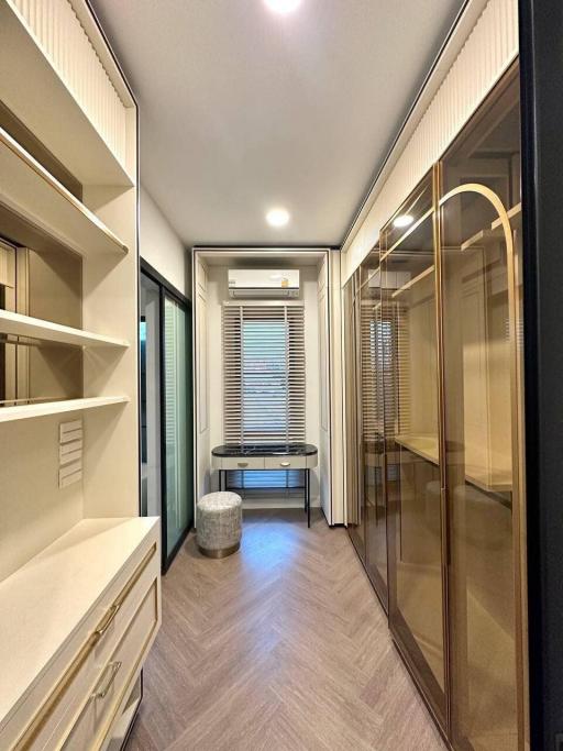 Modern hallway interior with built-in wardrobes and a seating area by the window