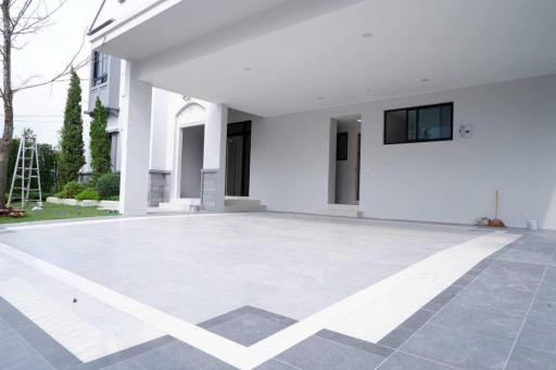 Spacious outdoor area of a modern home with covered patio