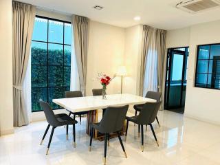 Bright and spacious dining room with modern furnishings and large windows