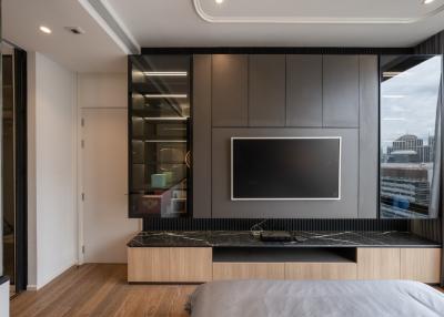 Modern bedroom with built-in kitchenette and city view