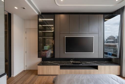 Modern bedroom with built-in kitchenette and city view