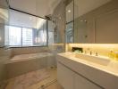 Modern bathroom interior with glass shower, bathtub, and city view