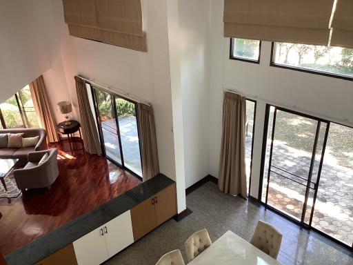 Spacious living room with high ceilings and large windows