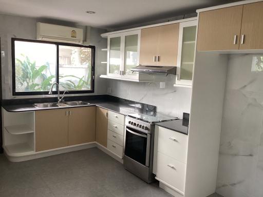 Modern kitchen with large window and stainless steel appliances