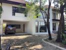 Spacious two-story house with paved driveway and garage