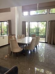 Spacious dining room with large table and garden view