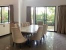 Spacious dining room with large table and garden view