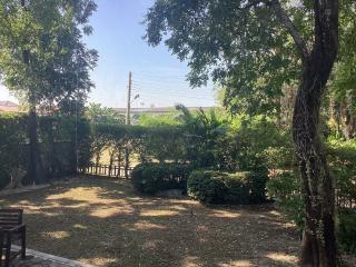 Spacious backyard with lush greenery and a volleyball net