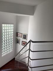 Modern staircase with glass blocks window and hardwood floors