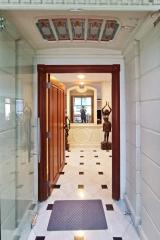 Elegant entrance hall with ornate ceiling and tiled floor