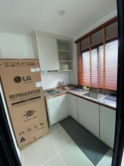 Modern kitchen with new refrigerator and ample cabinetry