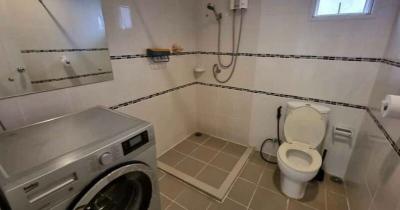 Bright and practical bathroom with laundry machine