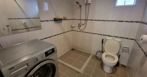 Bright and practical bathroom with laundry machine