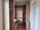 Cozy bedroom with wooden wardrobe and parquet flooring