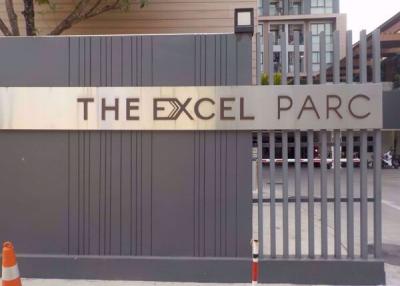 The entrance sign of The Excel Parc with a modern gate
