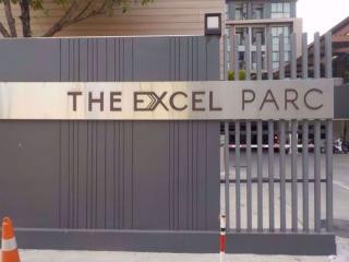 The entrance sign of The Excel Parc with a modern gate